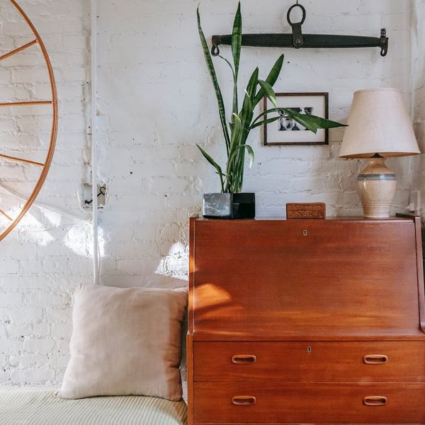 Cozy corner at home with a yoga mat, a plant, and soft light.